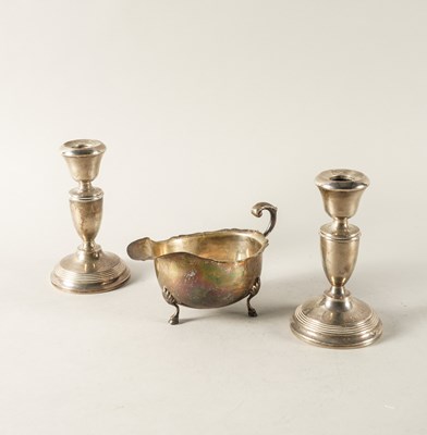 Lot 333 - A SILVER SAUCEBOAT AND A PAIR OF SILVER CANDLESTICKS (2)