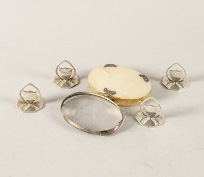 Lot 386 - A SET OF FOUR SILVER PLACE NAME OR MENU STANDS AND A SILVER AND MOTHER-OF-PEARL OVAL MAGNIFYING GLASS (5)