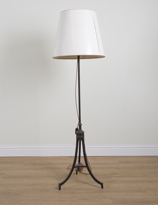 Lot 556 - A REGENCY STYLE JAPANNED METAL AND GILT-DECORAGED TRIPOD FLOOR STANDING LIGHT