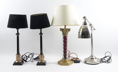 Lot 557 - A PAIR OF BLACK LACQUERED AND BRASS FINISHED COLUMN TABLE LAMPS (4)