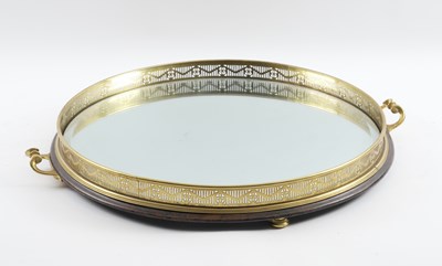 Lot 578 - A GILT-METAL AND MIRRORED GLASS CIRCULAR TRAY