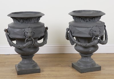 Lot 637 - A PAIR OF LARGE PATINATED CAST IRON URNS WITH DECORATIVE SWAGS (2)