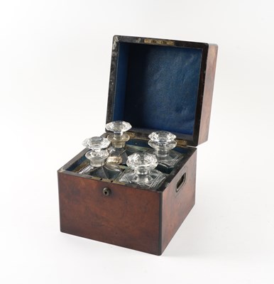 Lot 702 - A 19TH CENTURY FIGURED WALNUT FOUR BOTTLE DECANTER BOX