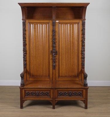 Lot 767 - HAMPTON AND SONS; A CARVED OAK CUPBOARD BACK OPEN ARM SETTLE