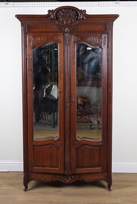 Lot 856 - AN 19TH CENTURY FRENCH CARVED OAK MIRRORED TWO DOOR ARMOIRE