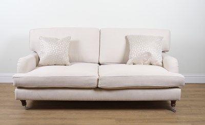 Lot 898 - A MODERN CREAM UPHOLSTERED THREE SEAT SOFA