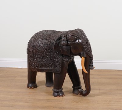 Lot 901 - AN EARLY 20TH CENTURY LARGE CARVED HARDWOOD ELEPHANT