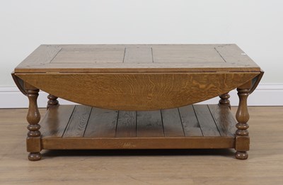 Lot 922 - AN OAK DROP FLAP OVAL COFFEE TABLE