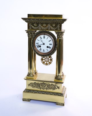 Lot 575 - A FRENCH EMPIRE STYLE POLISHED BRASS PORTICO CLOCK