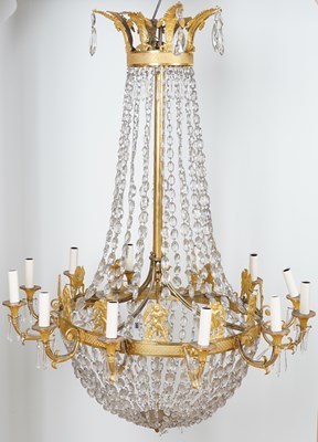 Lot 590 - A FRENCH EMPIRE REVIVAL ORMOLU AND CUT GLASS TWELVE-LIGHT CHANDELIER