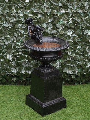 Lot 958 - A 19TH CENTURY BLACK PAINTED CAST-IRON URN WITH CHERUB MOUNT