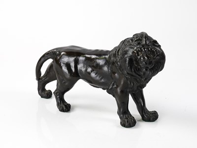 Lot 1268 - A JAPANESE BRONZE MODEL OF A STANDING LION
