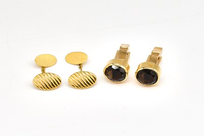 Lot 1829 - A PAIR OF GOLD AND SMOKY QUARTZ CUFFLINKS AND ANOTHER PAIR OF CUFFLINKS (2)