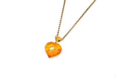 Lot 1836 - A GOLD MOUNTED AMBER PENDANT WITH A GOLD NECKCHAIN (2)