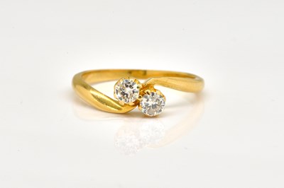 Lot 1845 - AN 18CT GOLD DIAMOND TWO STONE CROSSOVER RING