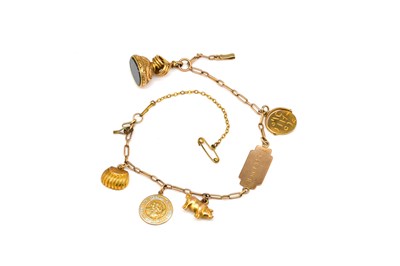 Lot 1899 - A GOLD IDENTITY BRACELET FITTED WITH FIVE PENDANTS AND CHARMS