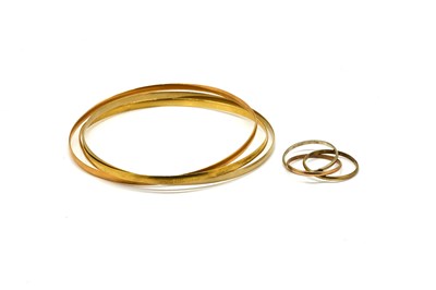Lot 1905 - A THREE COLOUR GOLD BANGLE AND A SIMILAR RING (2)