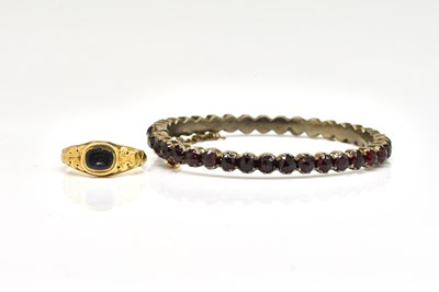 Lot 1906 - A GOLD RING AND A GARNET BRACELET (2)